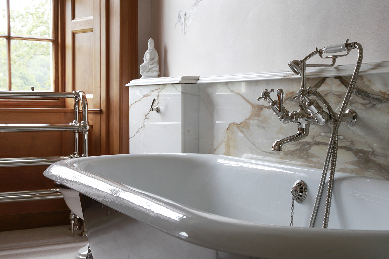 The warm caramel veined book matched marble complements the Victorian pine paneling.