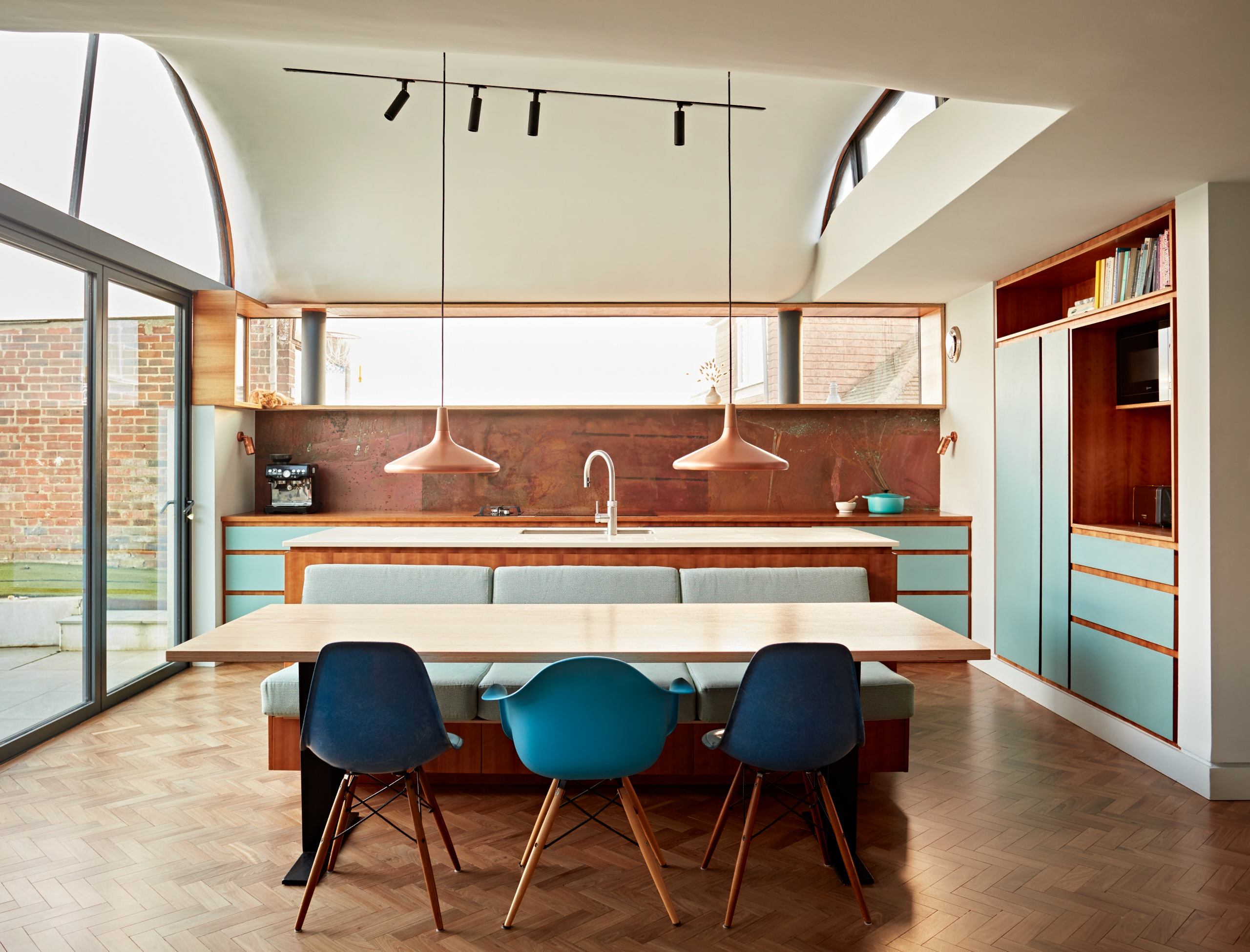 Shades of blue and copper create a bold and fun palette complete with custom made banquette seating.