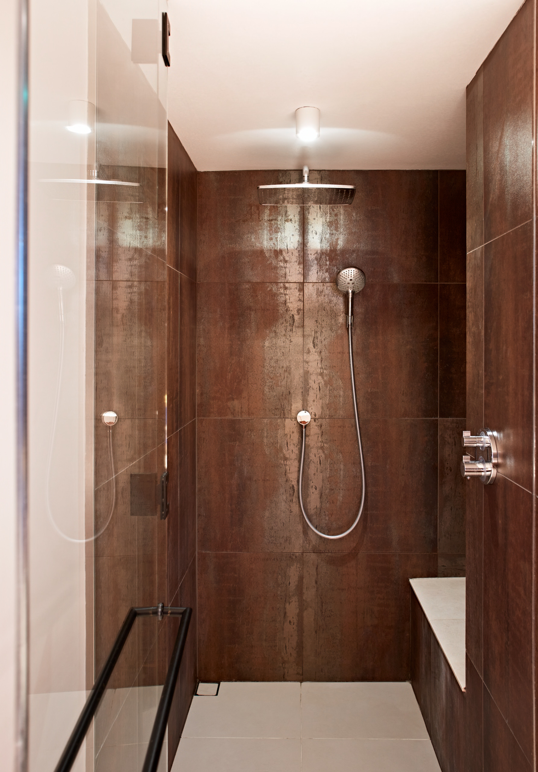 Floor to ceiling copper-ore tiles in the tram shower room create warmth and a sense of luxury.