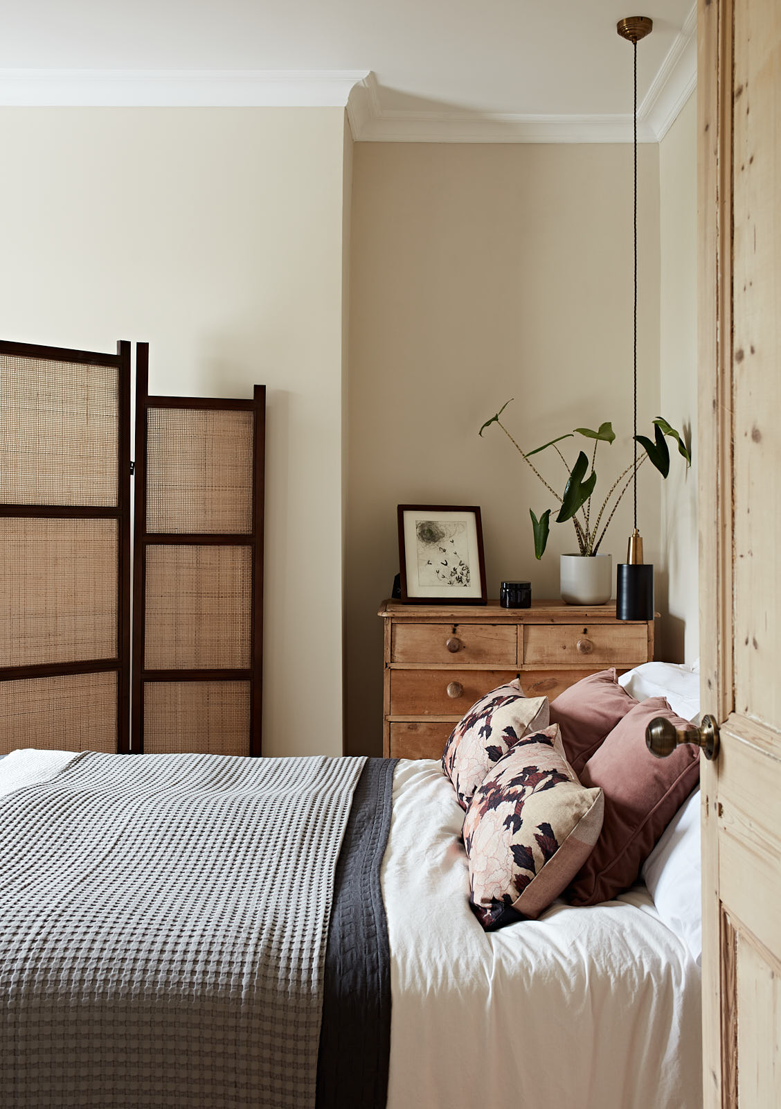 A light filled bedroom with Japanese accents and wooden screening with natural texture