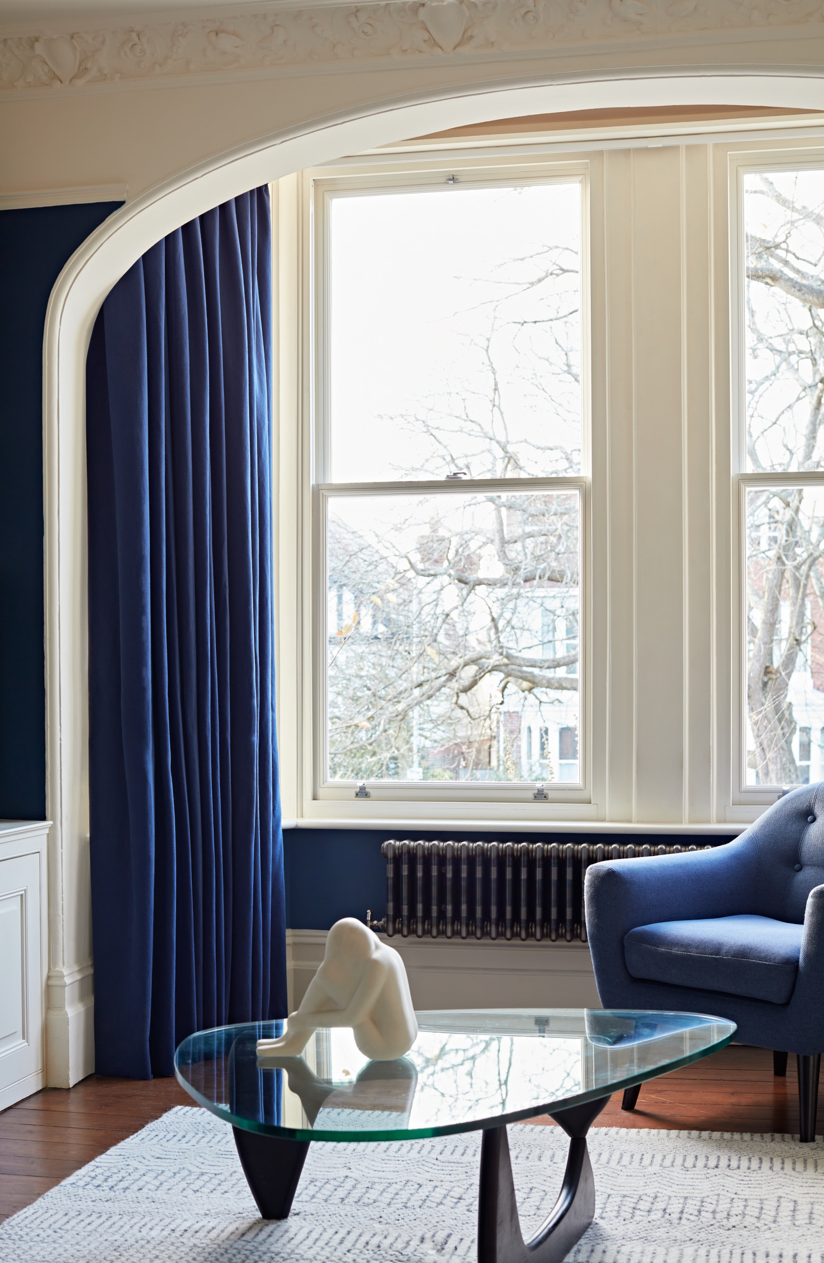 We created a more formal sitting room, adding texture and panelling for a traditional yet comfortable space.