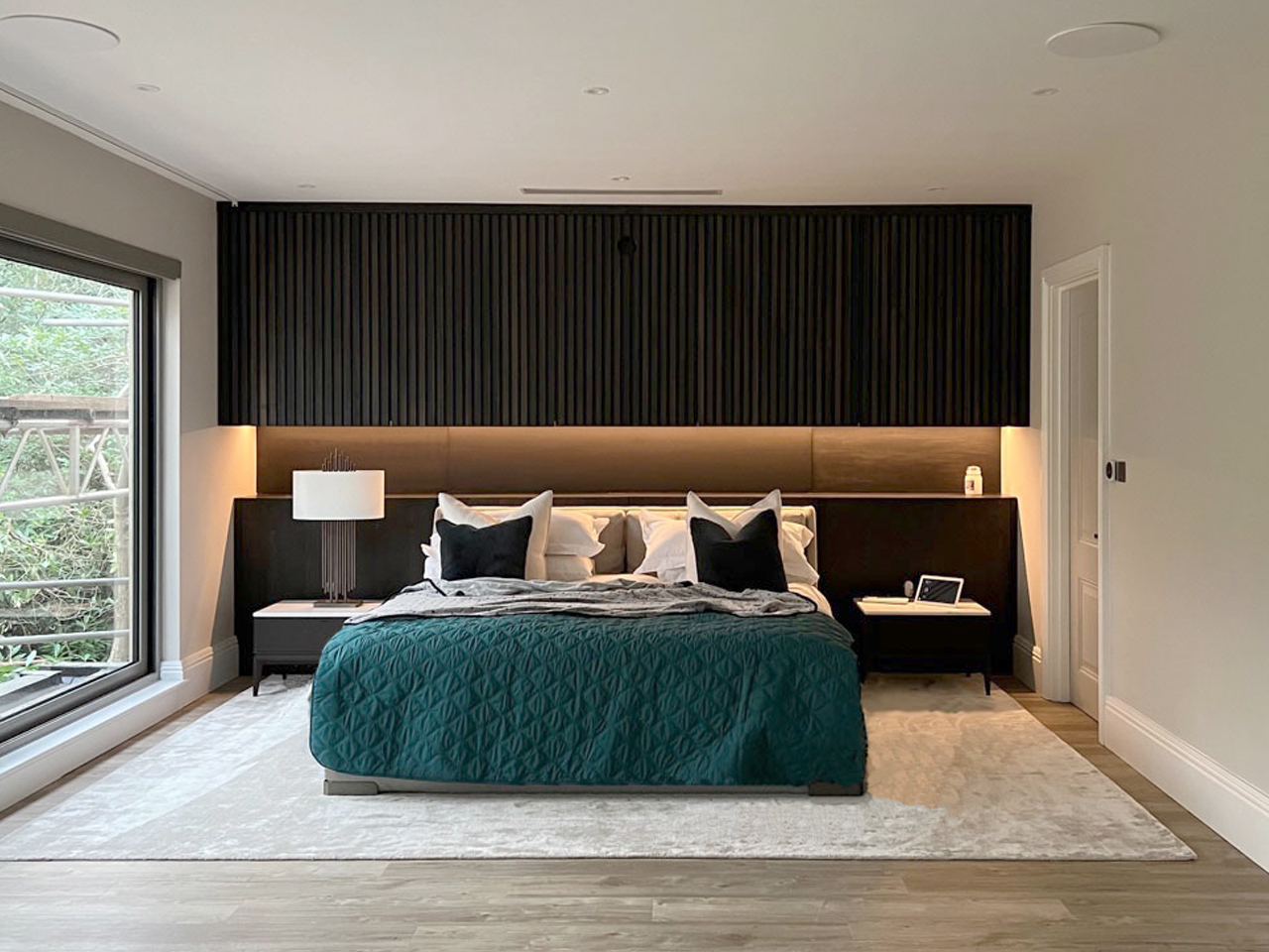 master bedroom feature wall with storage and projector in solid and veneer wood