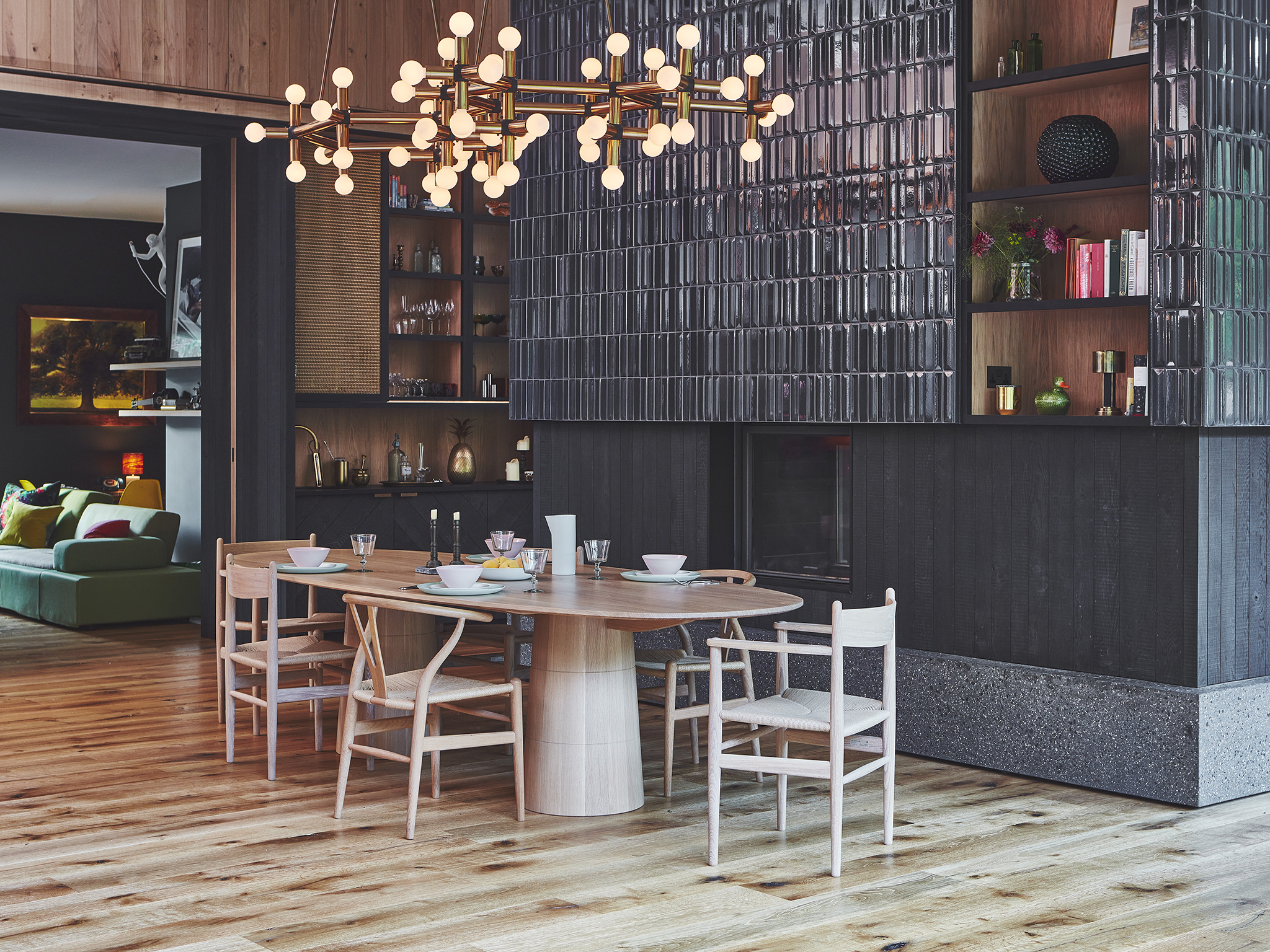 A dining table against a large tiled fireplace