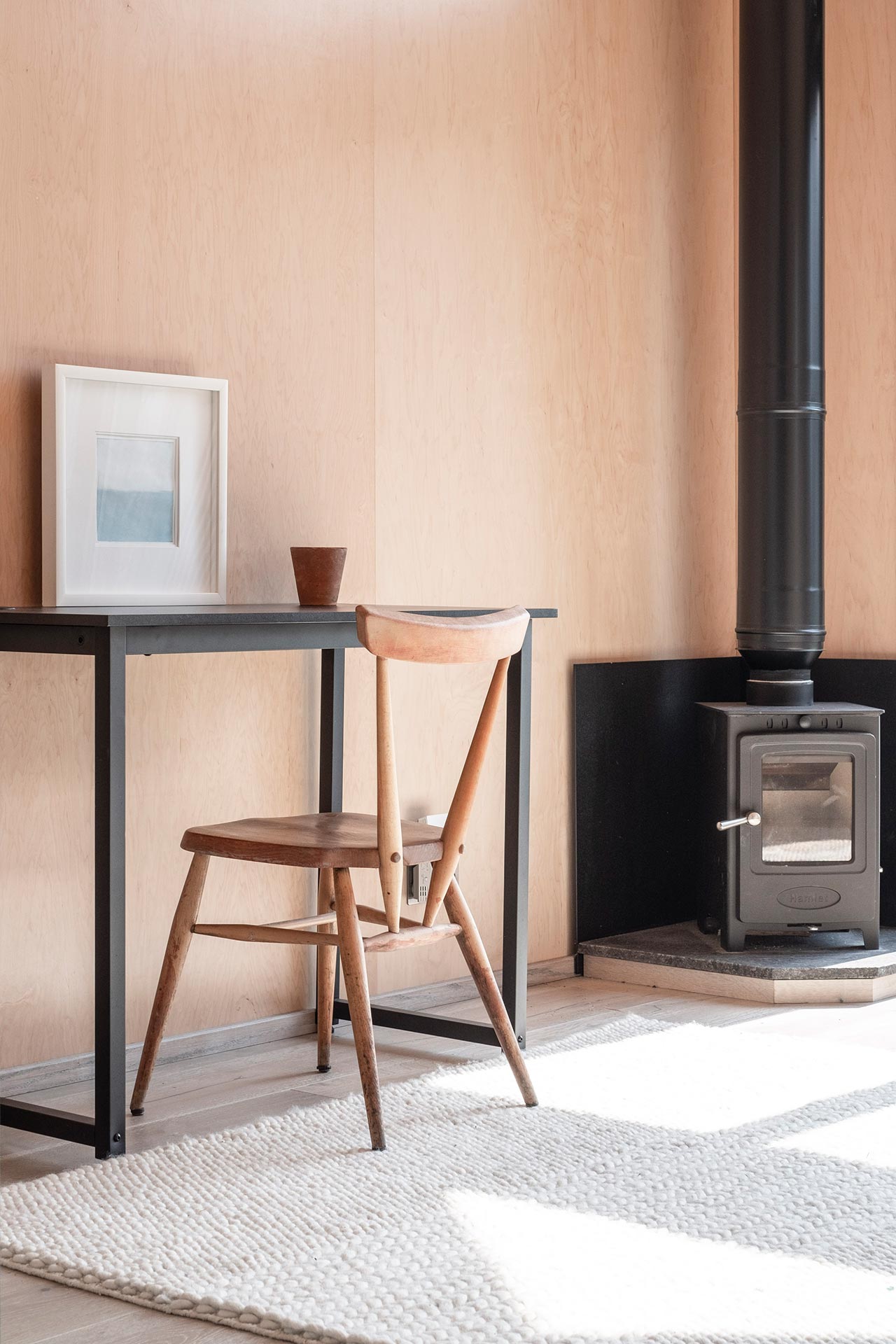 Contemporary furniture with chair and desk in front of log burner