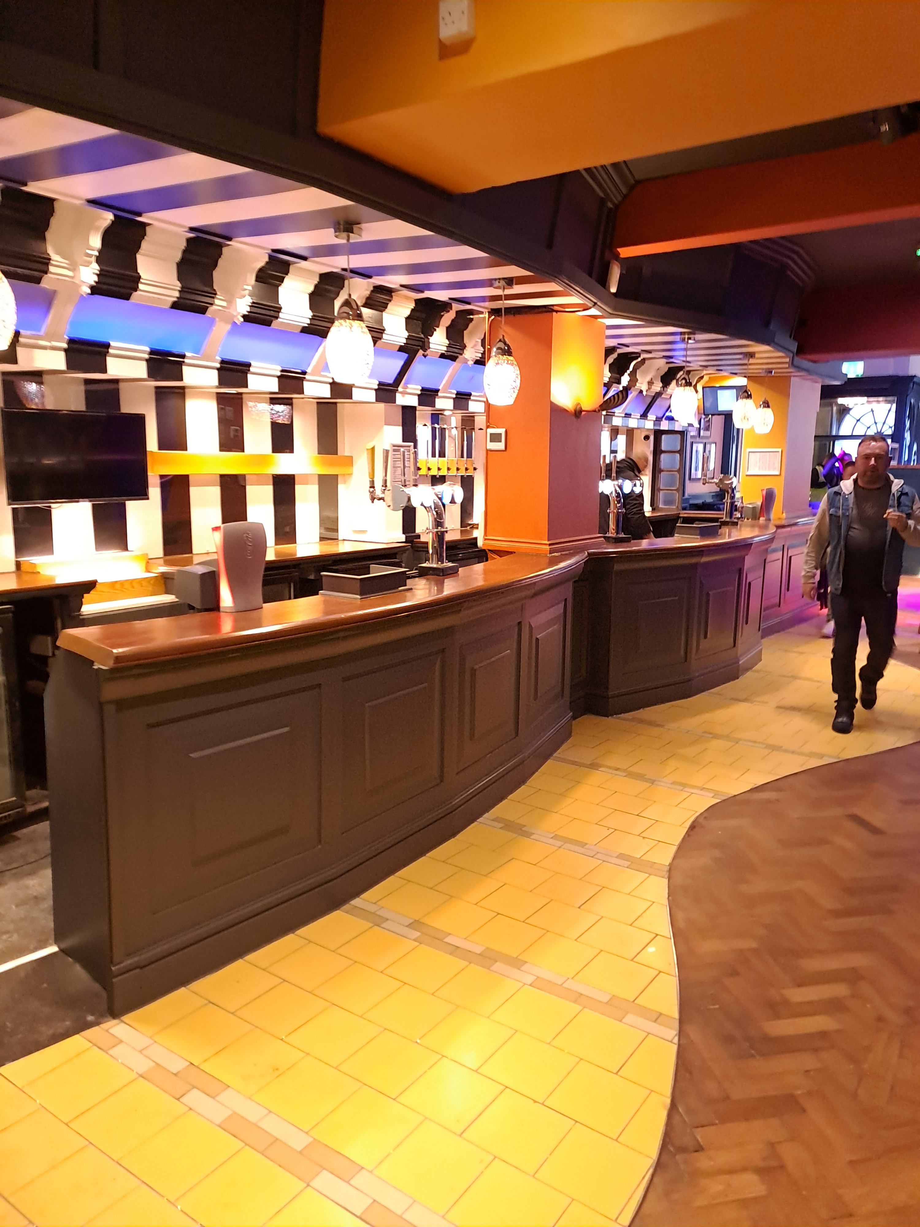 Feature bar with yellow brick road tiles and black and white stripe ceiling