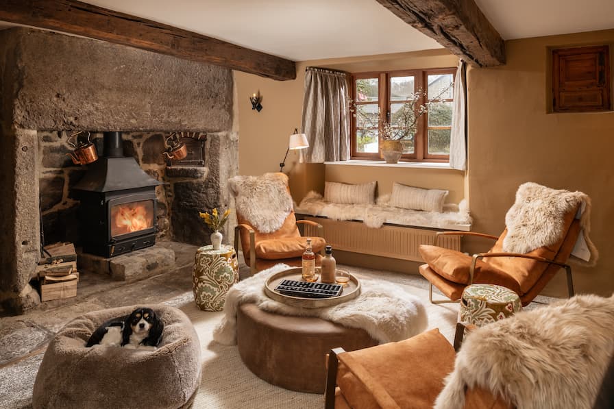 Cosy Boot Room with leather ottoman and slipper chairs, covered in Dartmoor sheepskins