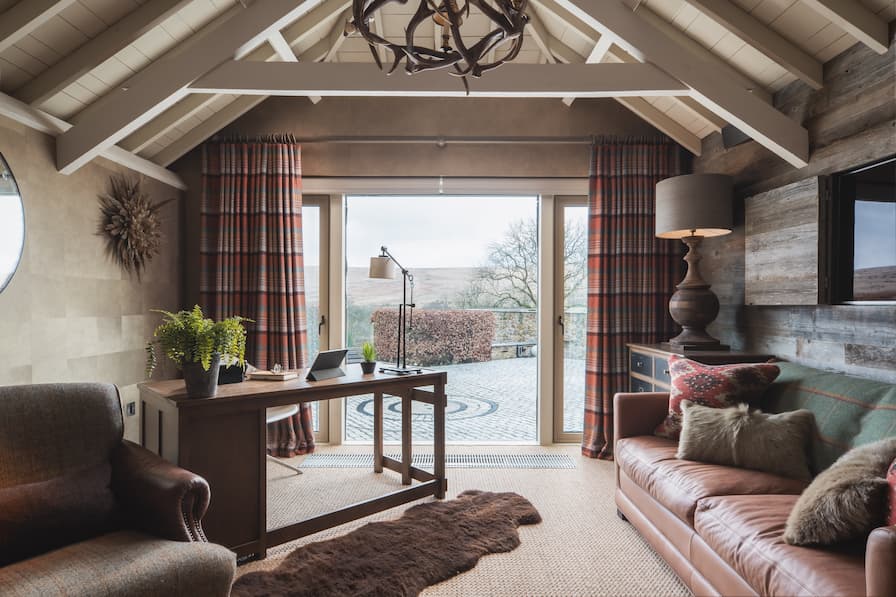 Lounge area with painted beams and working from home desk