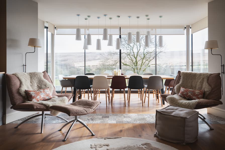 Long dining table with statement pendant lighting above