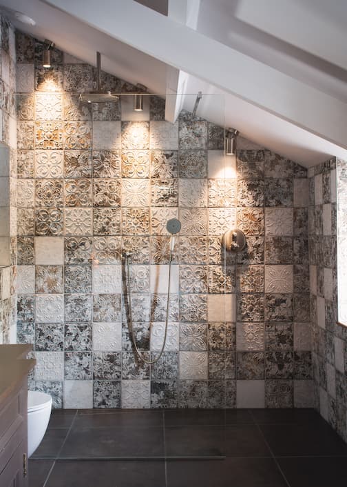 Patterned tile shower room, illuminated by sportlights