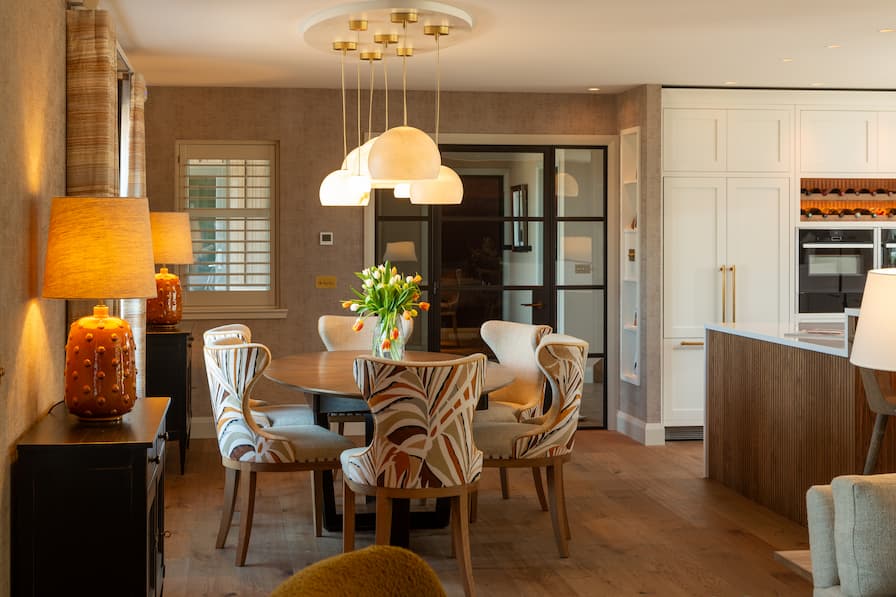 Bespoke upholstered chairs with statement pendant light above table