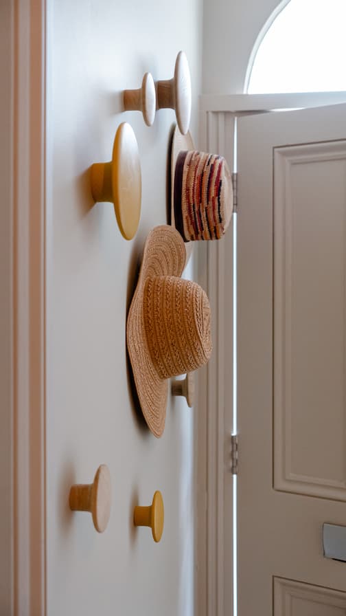 Hats arranged on decorative hooks