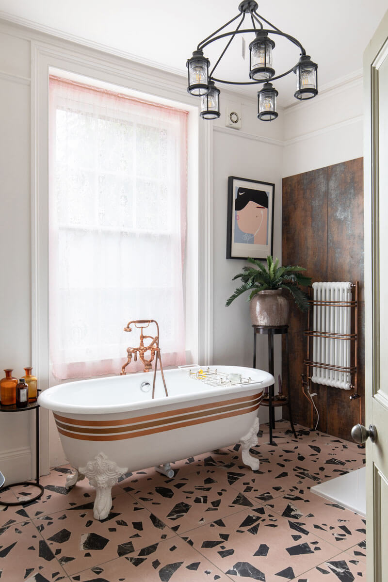 Guest Bathroom with slipper stripped bath and lace curtains