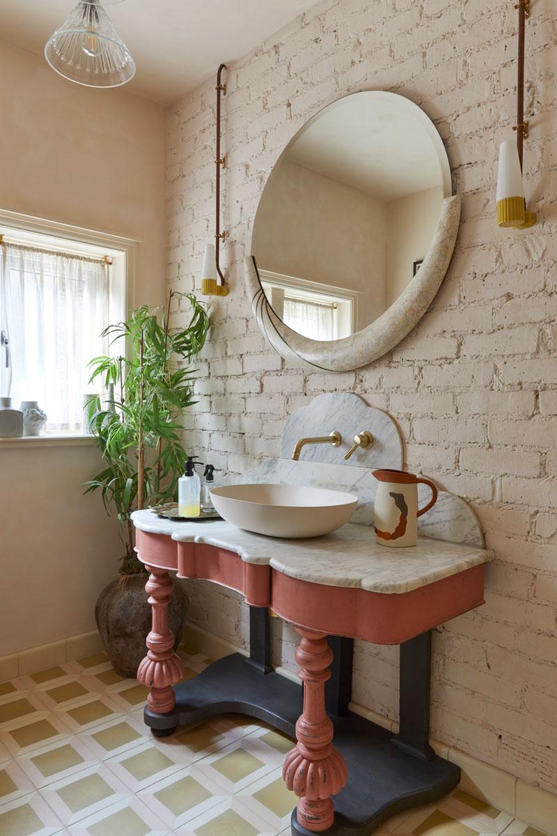 Cloakroom with vintage vanity unit and mirror