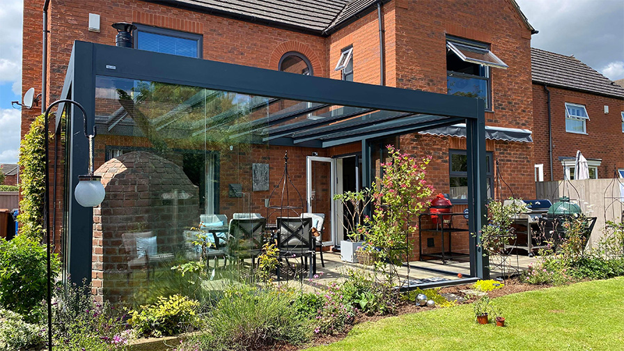 Grey framed glass room with integrated pizza oven