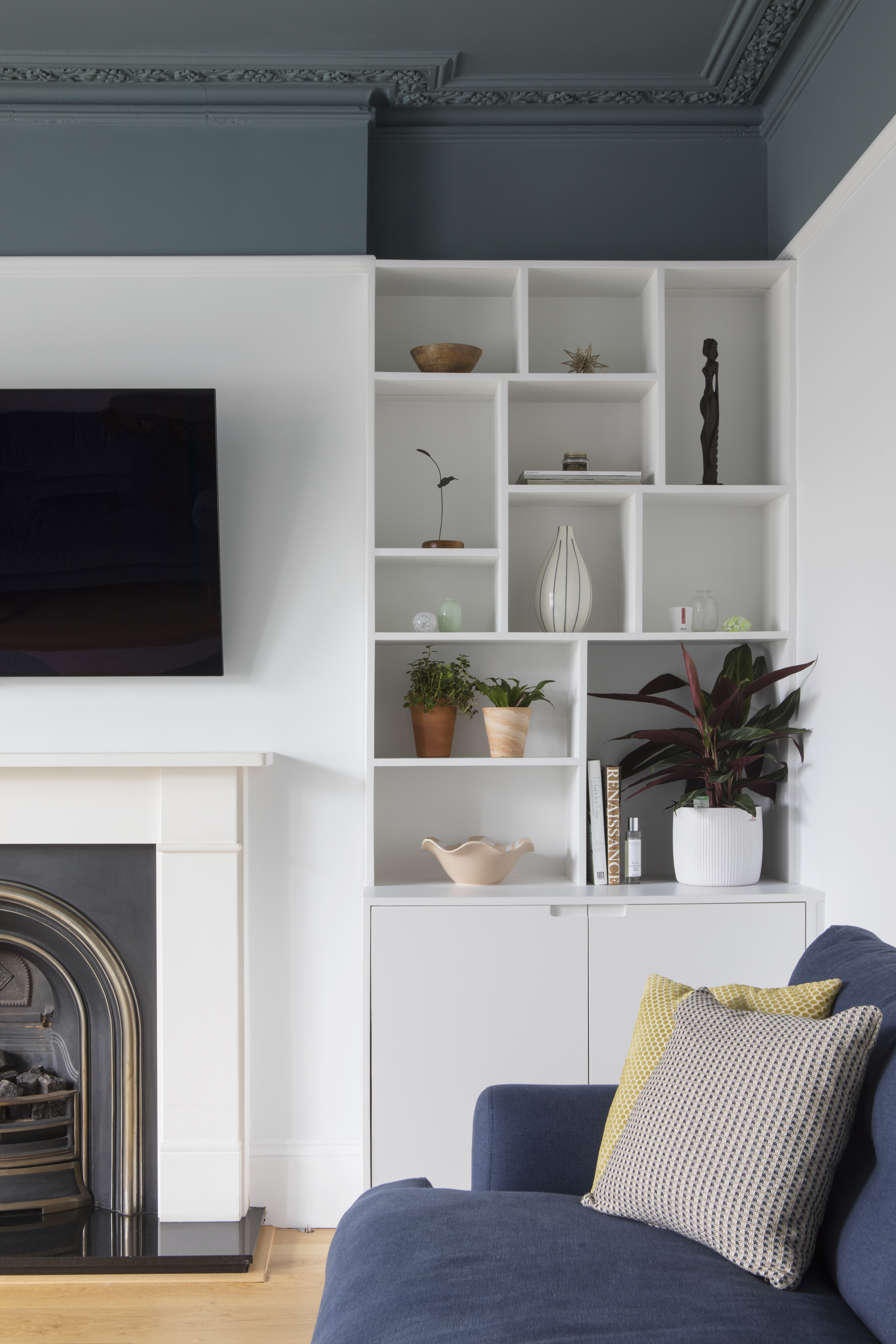 Mid century shelf and cupboard alcove storage.  Dark blue ceiling.