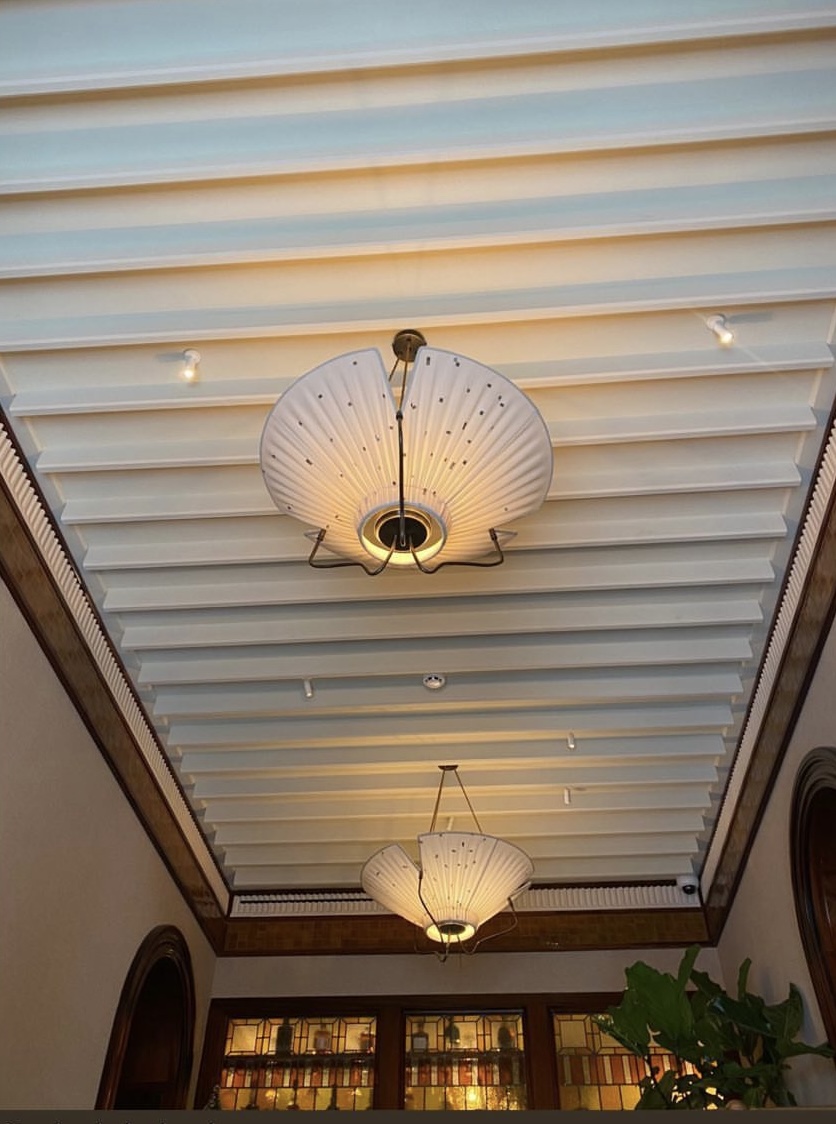 A view of the antique fabric and brass uplighters mounted at the lobby area