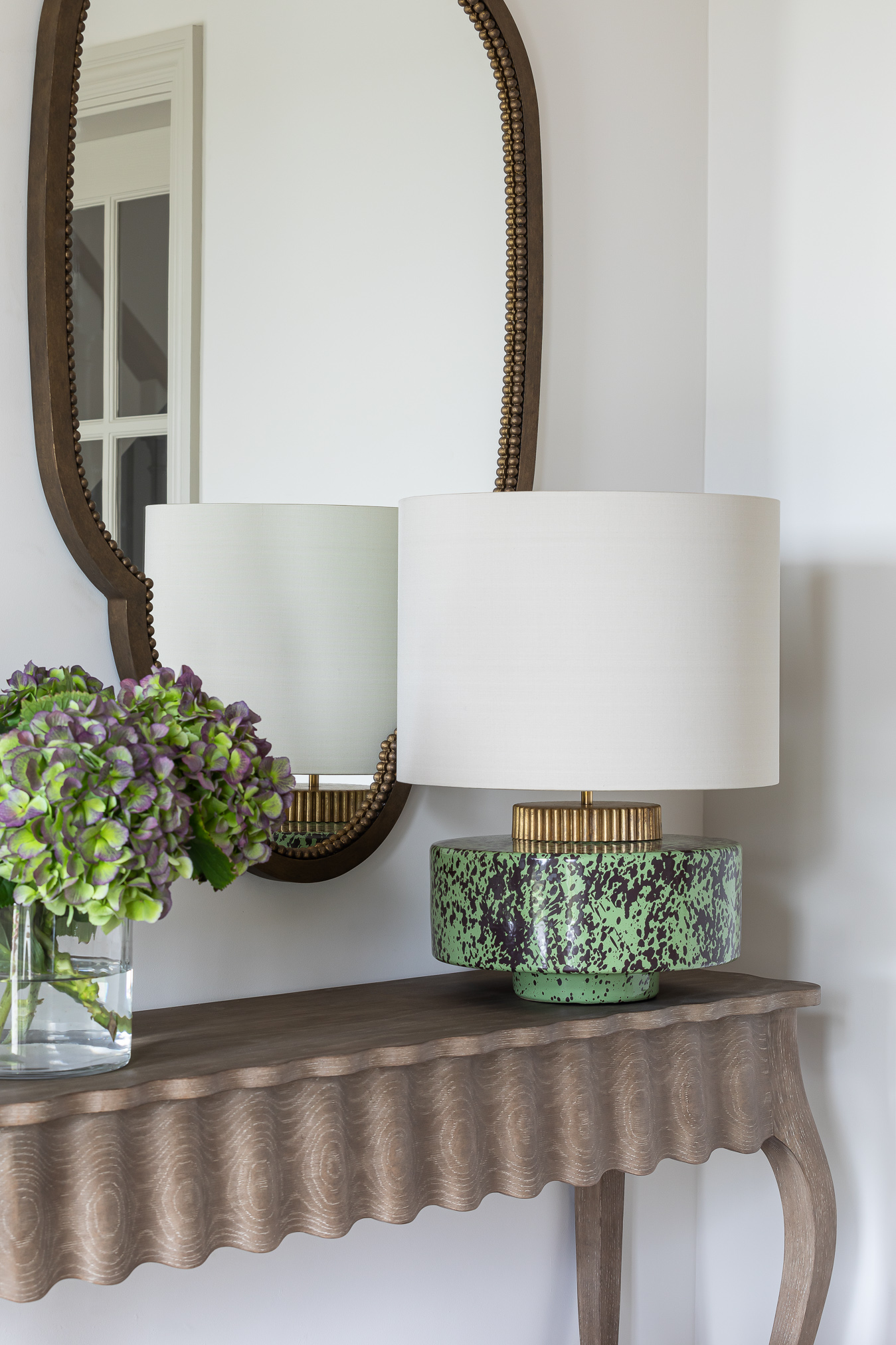 Traditional hallway oak console table with china Porta Romana Marlowe lamp and mirror