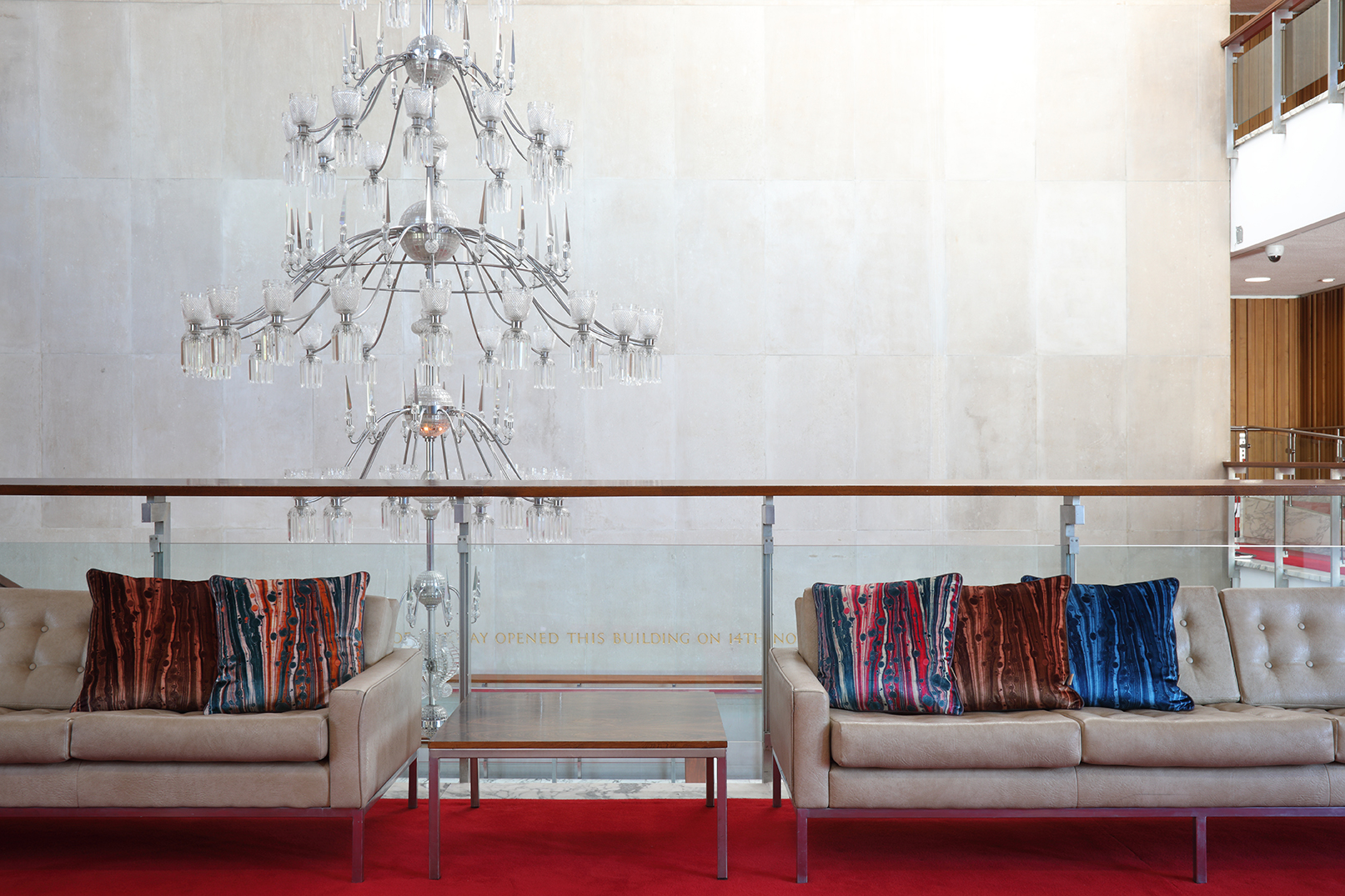 Grand stairwell at Newcastle Civic Centre with chandelier and red carpet. Susi Bellamy cushions on cream button backed sofas