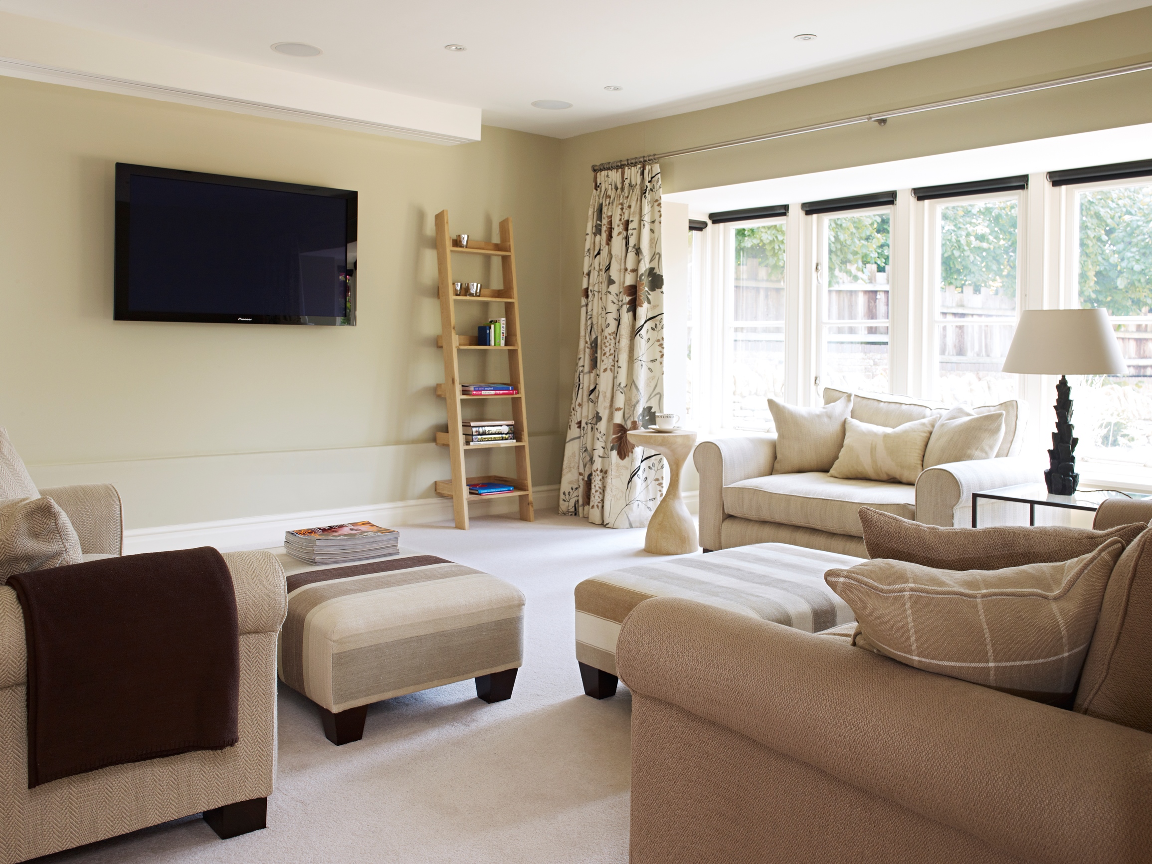 Family TV room in a 50’s extension, planned for comfort, practicality and chilling, with blackout window treatments for the projector screen