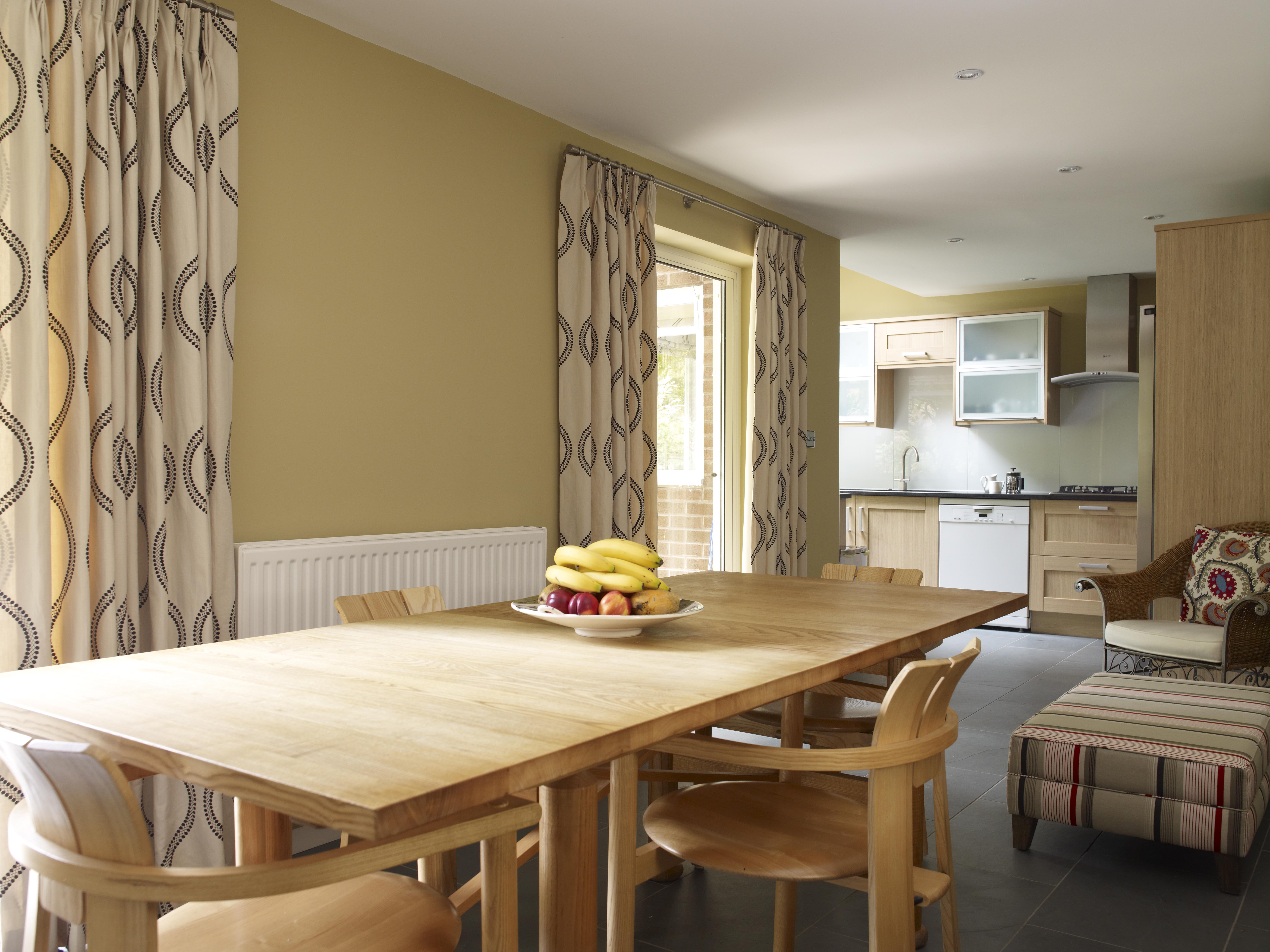 A bespoke oak dining table and chairs were repositioned to a previously cramped sink and working area visible directly from the entrance hall