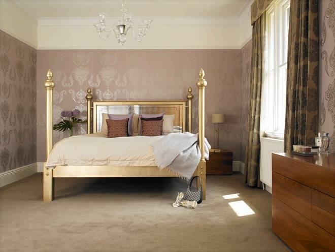 A glamorous master bedroom with plentiful but discreet bespoke walnut storage in the dressing area and en-suite leading off the room 