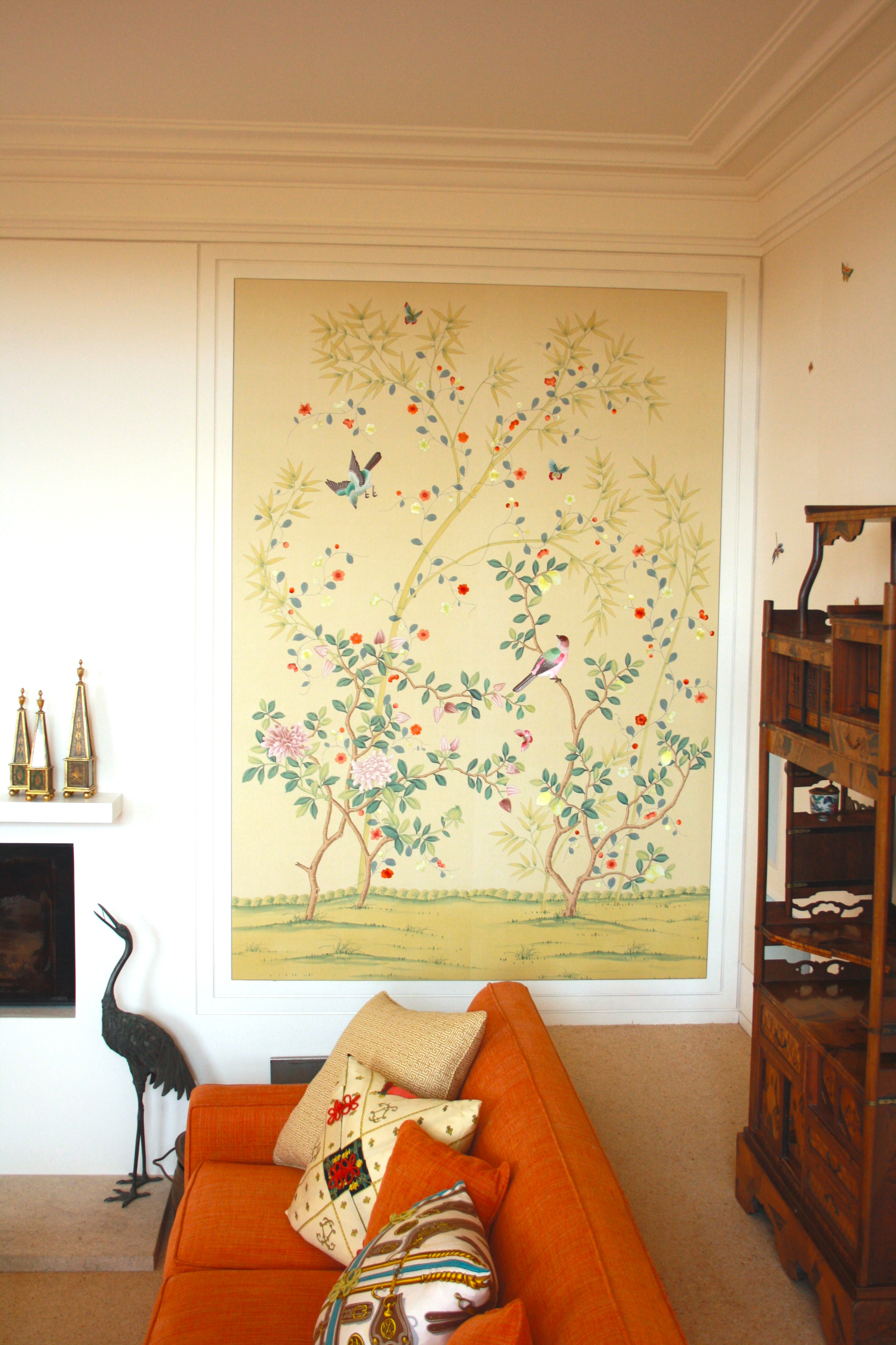 Chinoiserie panels surround the burnt orange sofa with its Hermes Scarf cushions