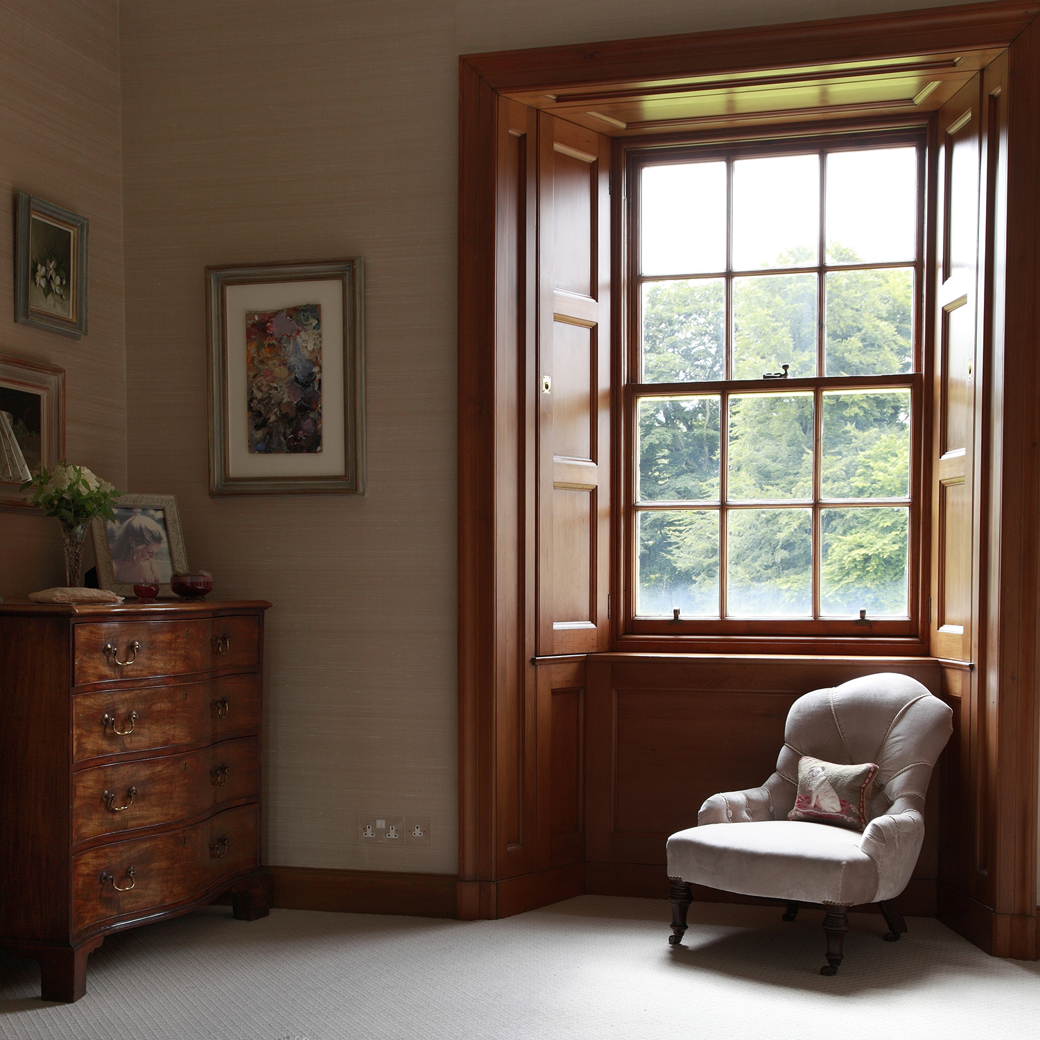 Silk lined walls and a small antique nursing chair covered in a silk velvet to match.