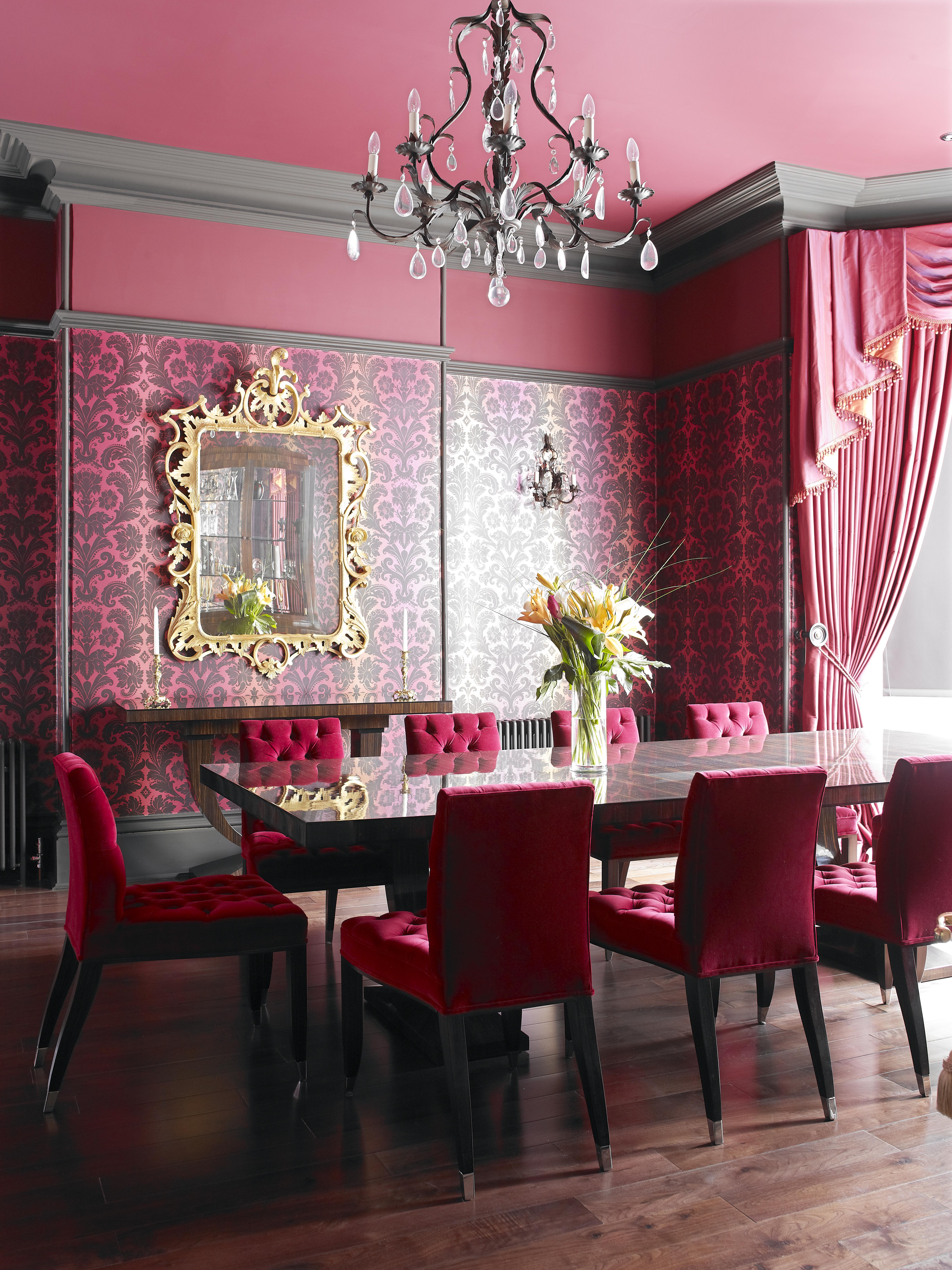 A matching Macassar ebony console and sideboard, gilt carved mirror frame, gilt light fittings and iridescent wallcovering add to the drama