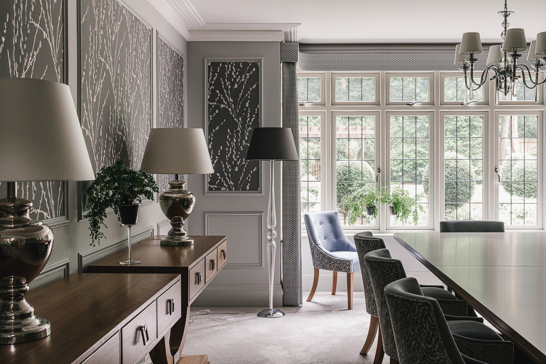 Luxury dining room with walnut finishes and light grey/blue colour scheme.