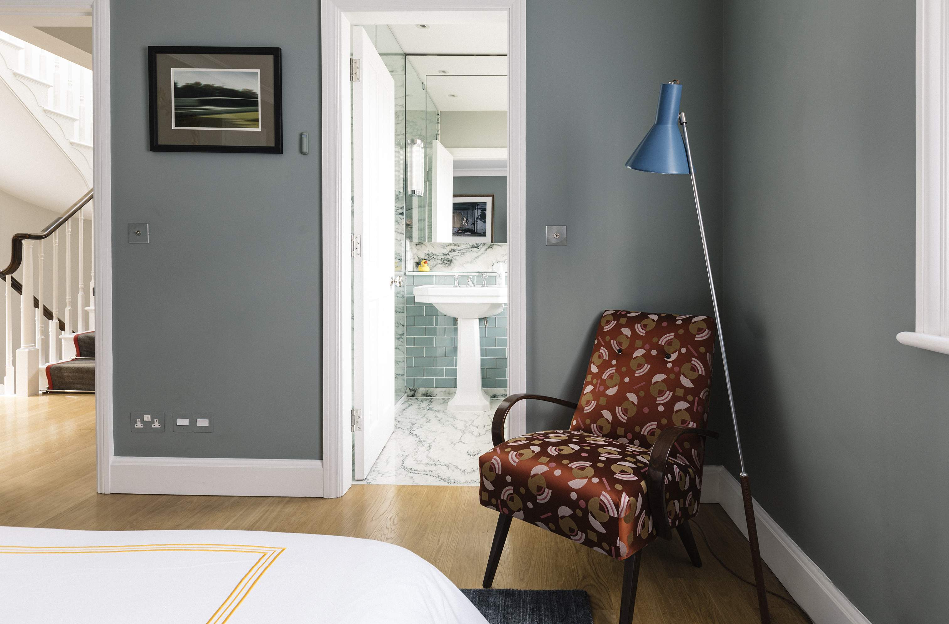 The restful guest bedroom allows a view to the Art Deco inspired en-suite bathroom.