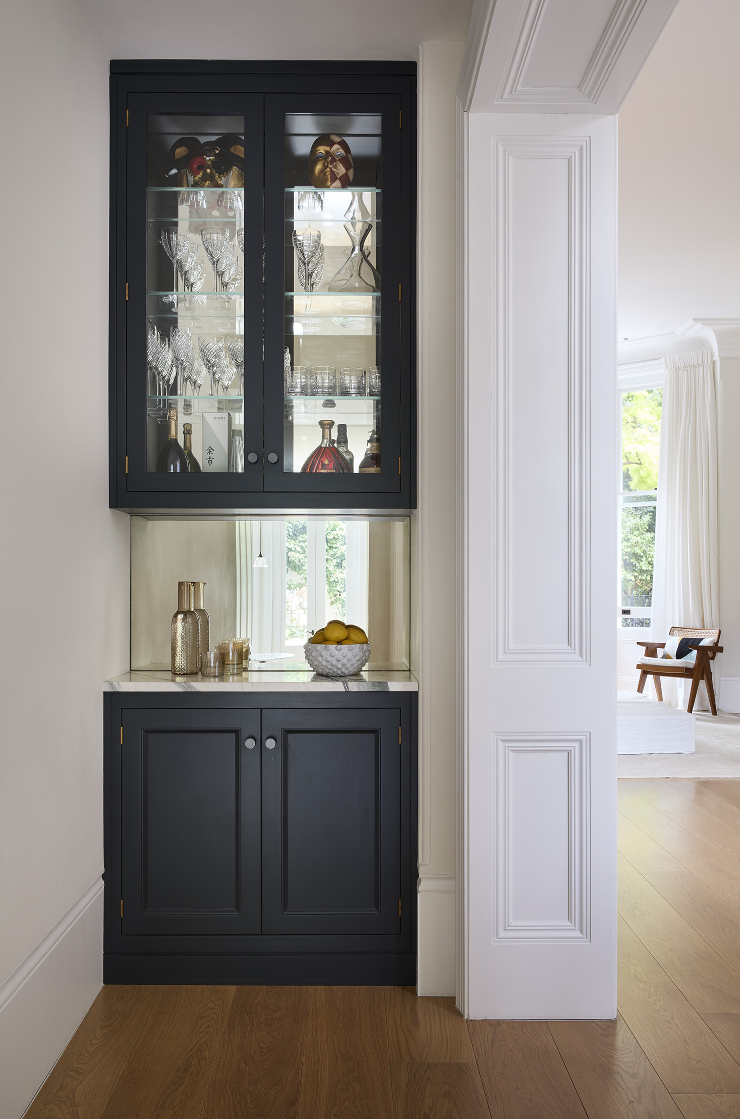 A single dark grey base unit with glazed unit above & mirrored backsplash 