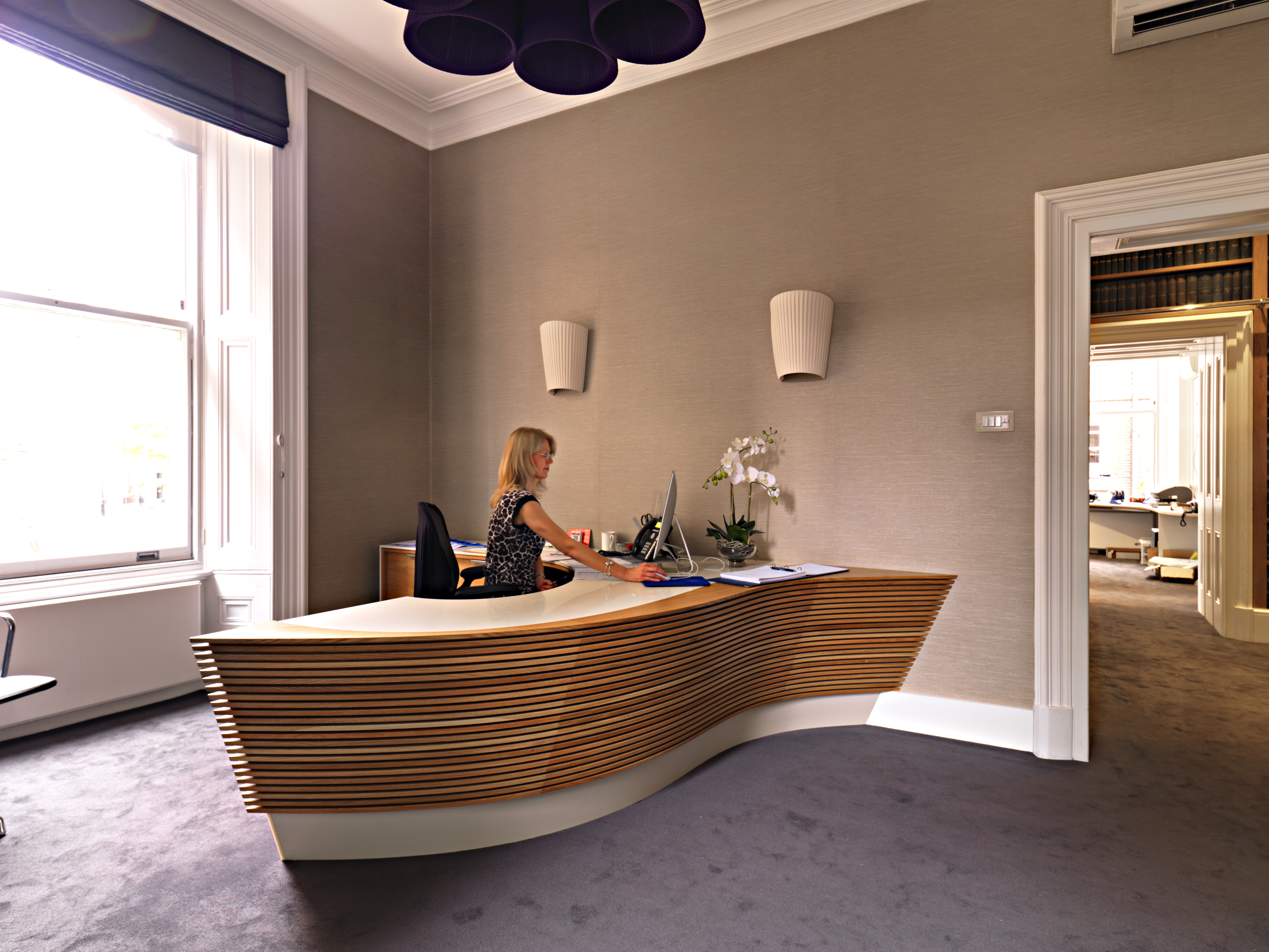 Slatted oak reception desk by Williams Ridout