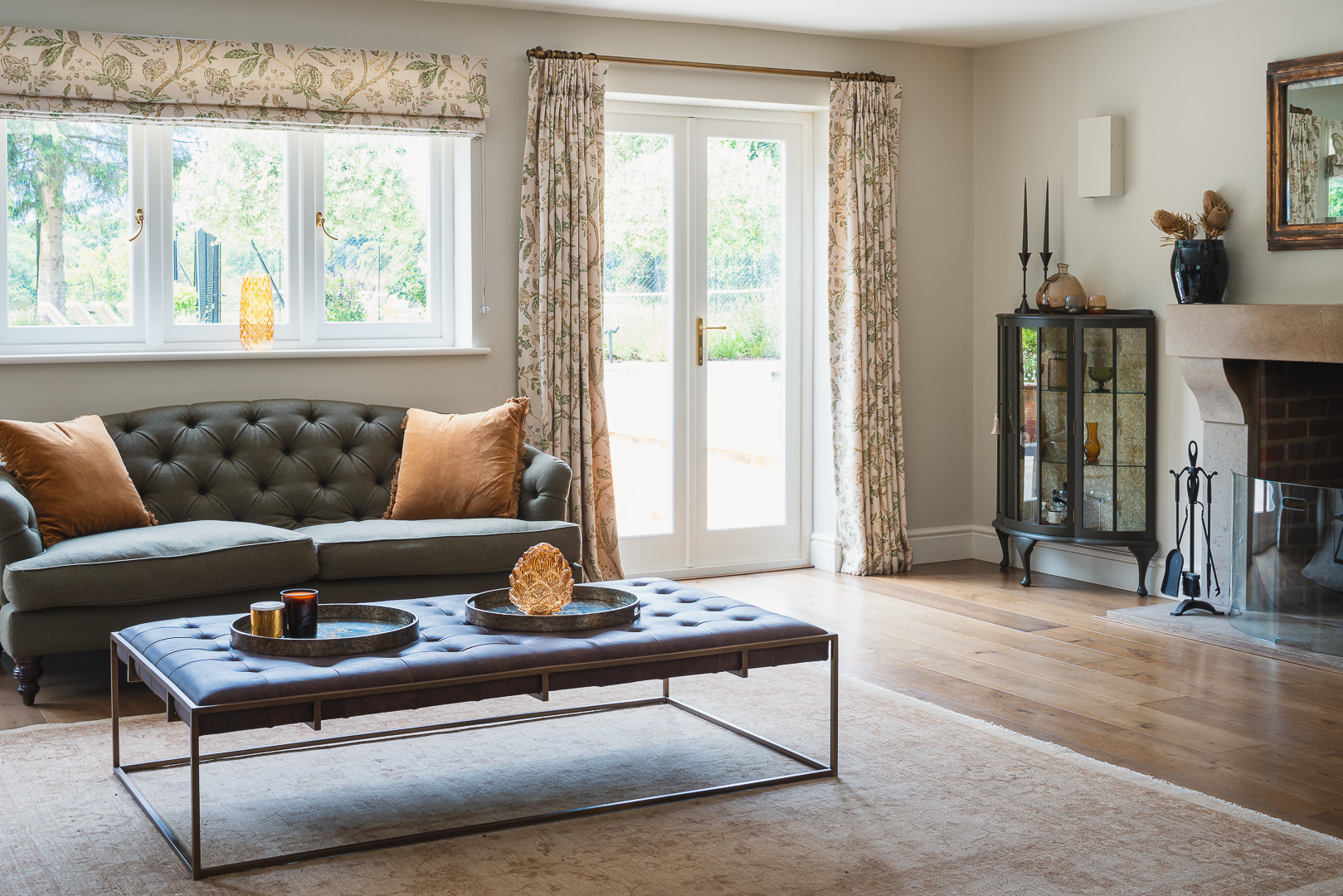 Living room with Chesterfield style sofas, dark wood, leather and  green and yellow ochre colours.