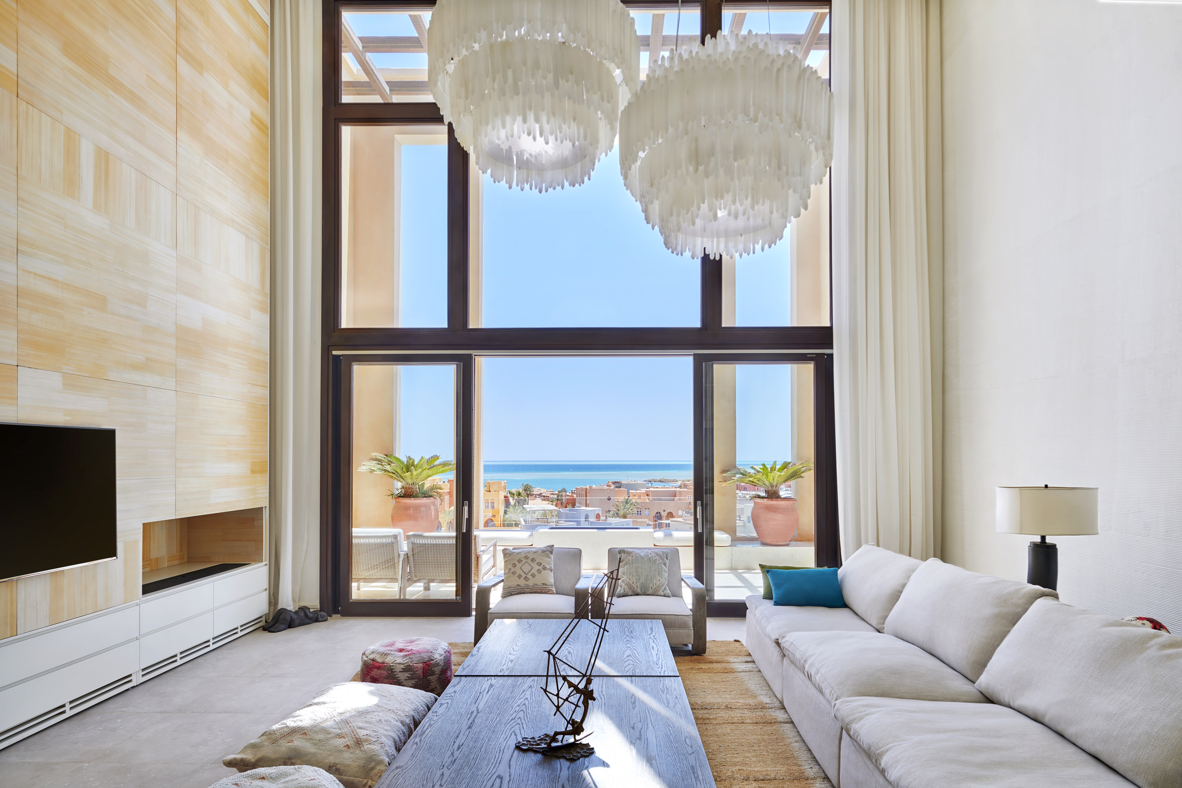 Living room with floor to ceiling Palm Reed storage unit