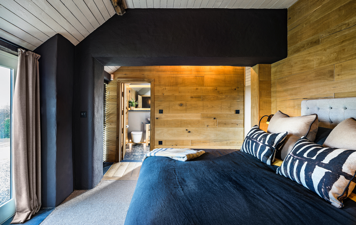 A smart, masculine bedroom was requested for this coastal cottage