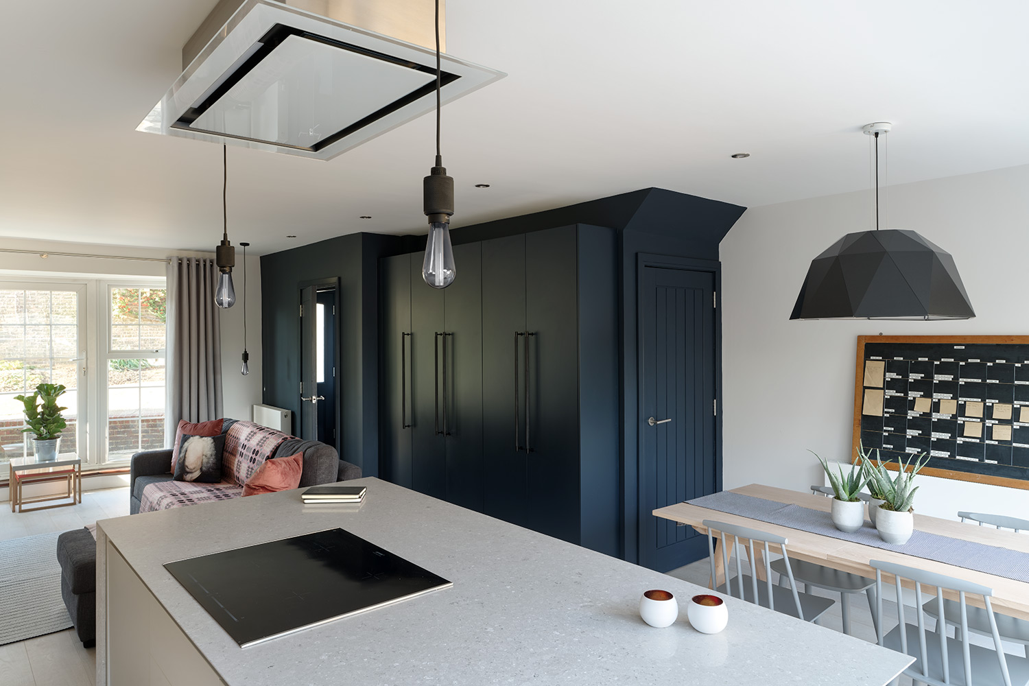 kitchen island; ceiling mounted extractor; wall of storage