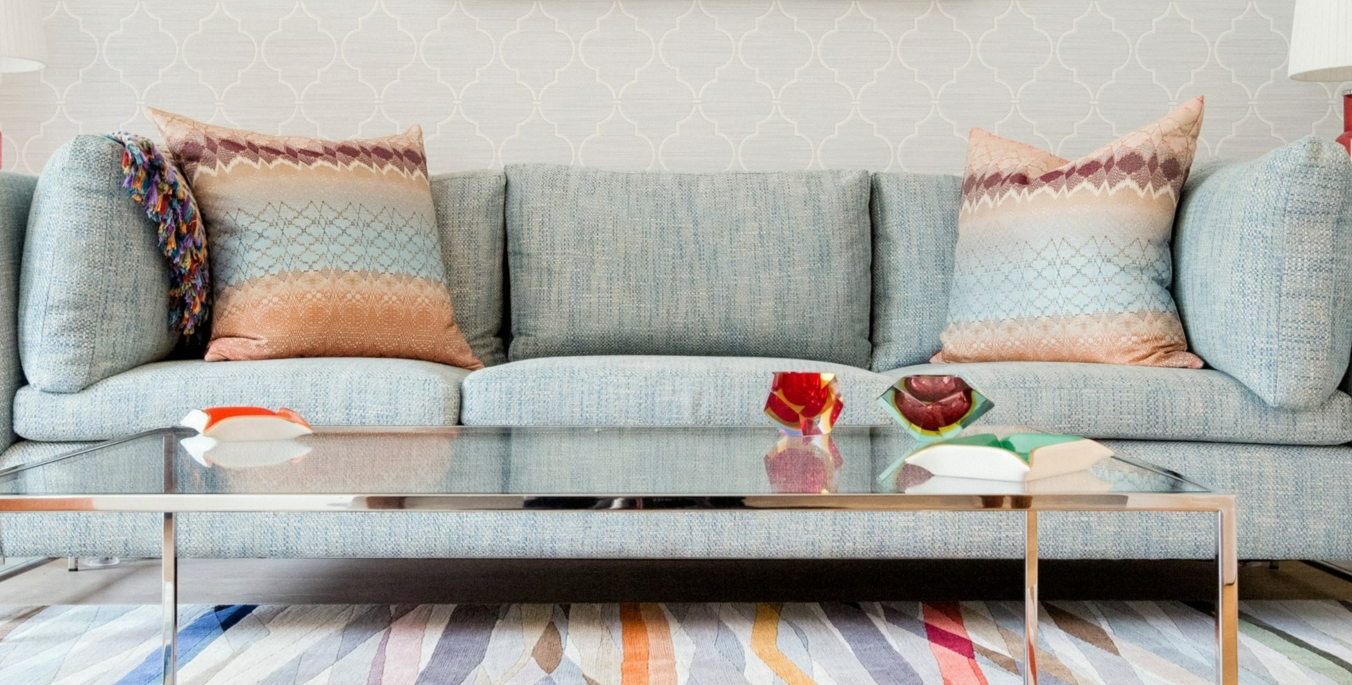 Colourful slices of colour run throughout the rug. The Missoni cushions add a playful touch to the cool blue sofa.