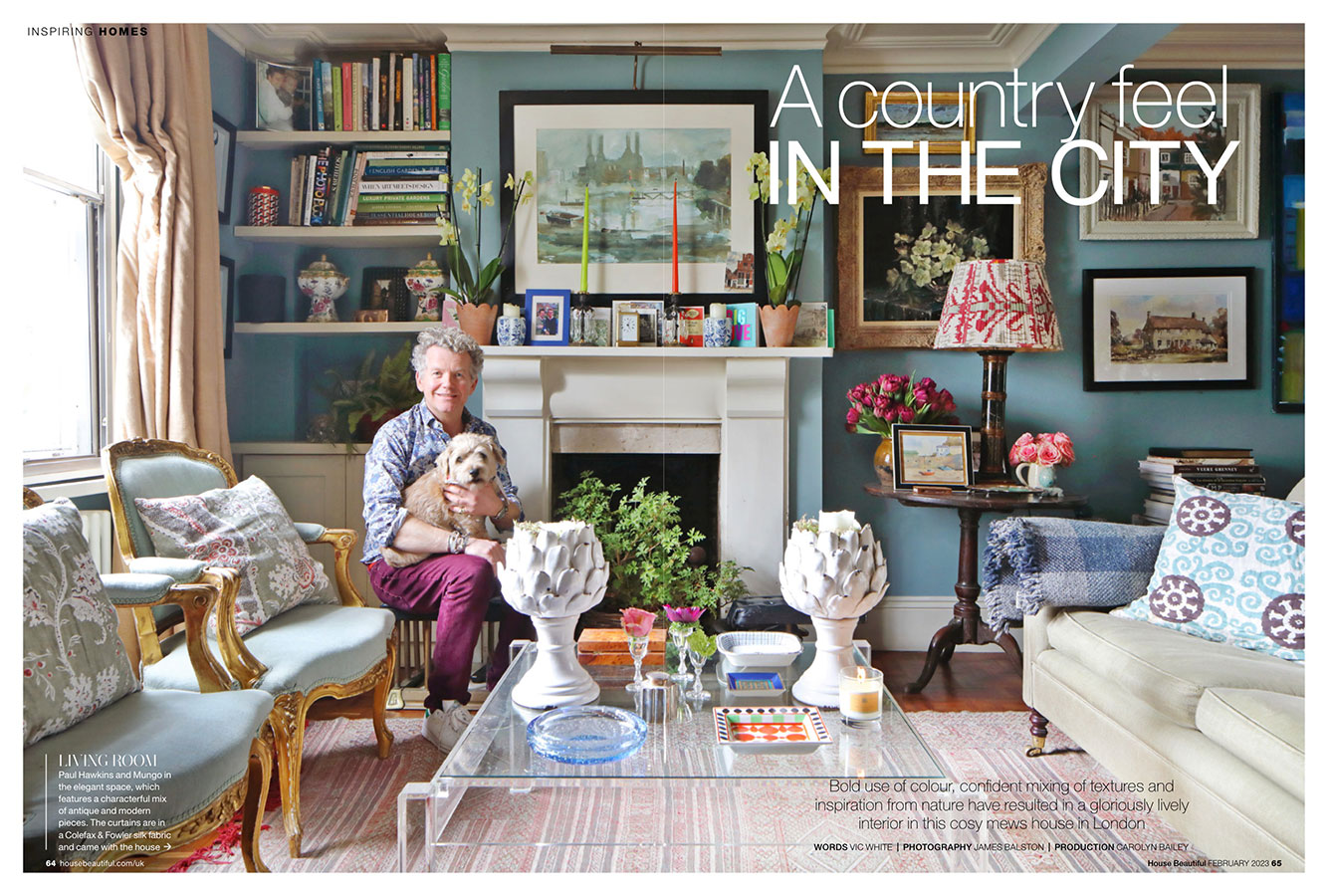 Paul Hawkins and his dog sitting in the living room at his pretty Chelsea home