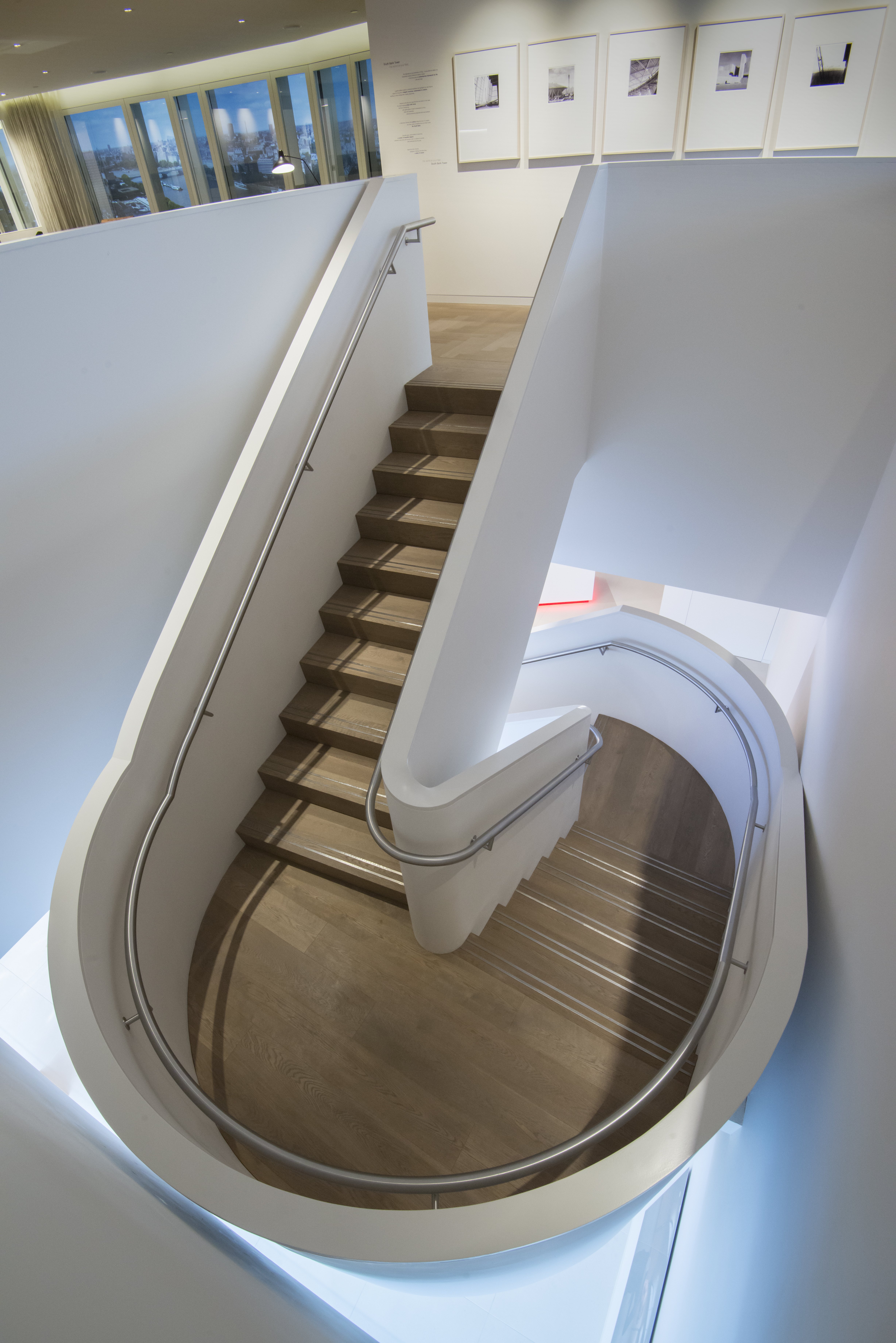 Fumed Oak Flooring clad to spiral stair case with polished metal grips