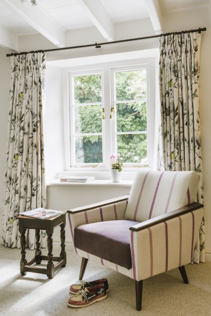 Chair and curtains in Designers Guild fabrics. Curtain pole from Bradley Collection