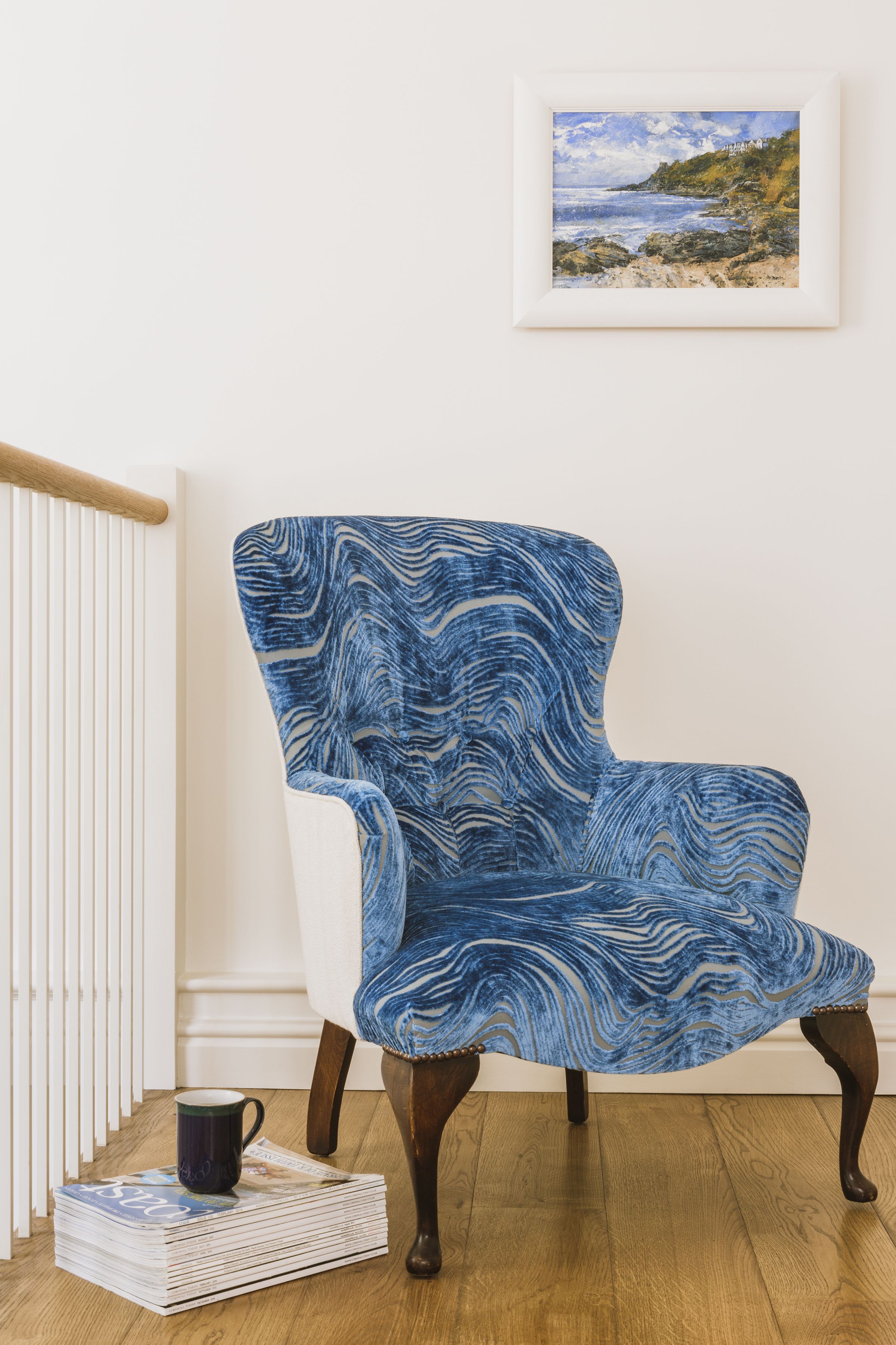 Traditional chair reupholstered in Designers Guild fabric, oak flooring and oak handrail