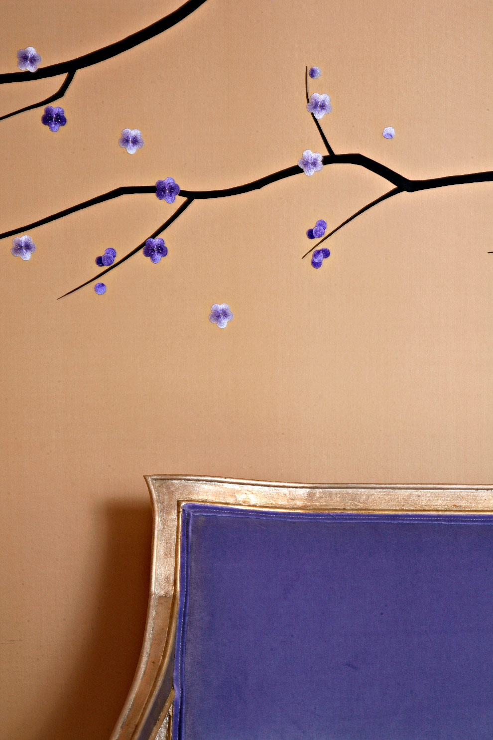 Blossoms trail across a bench which provides seating for the piano area.