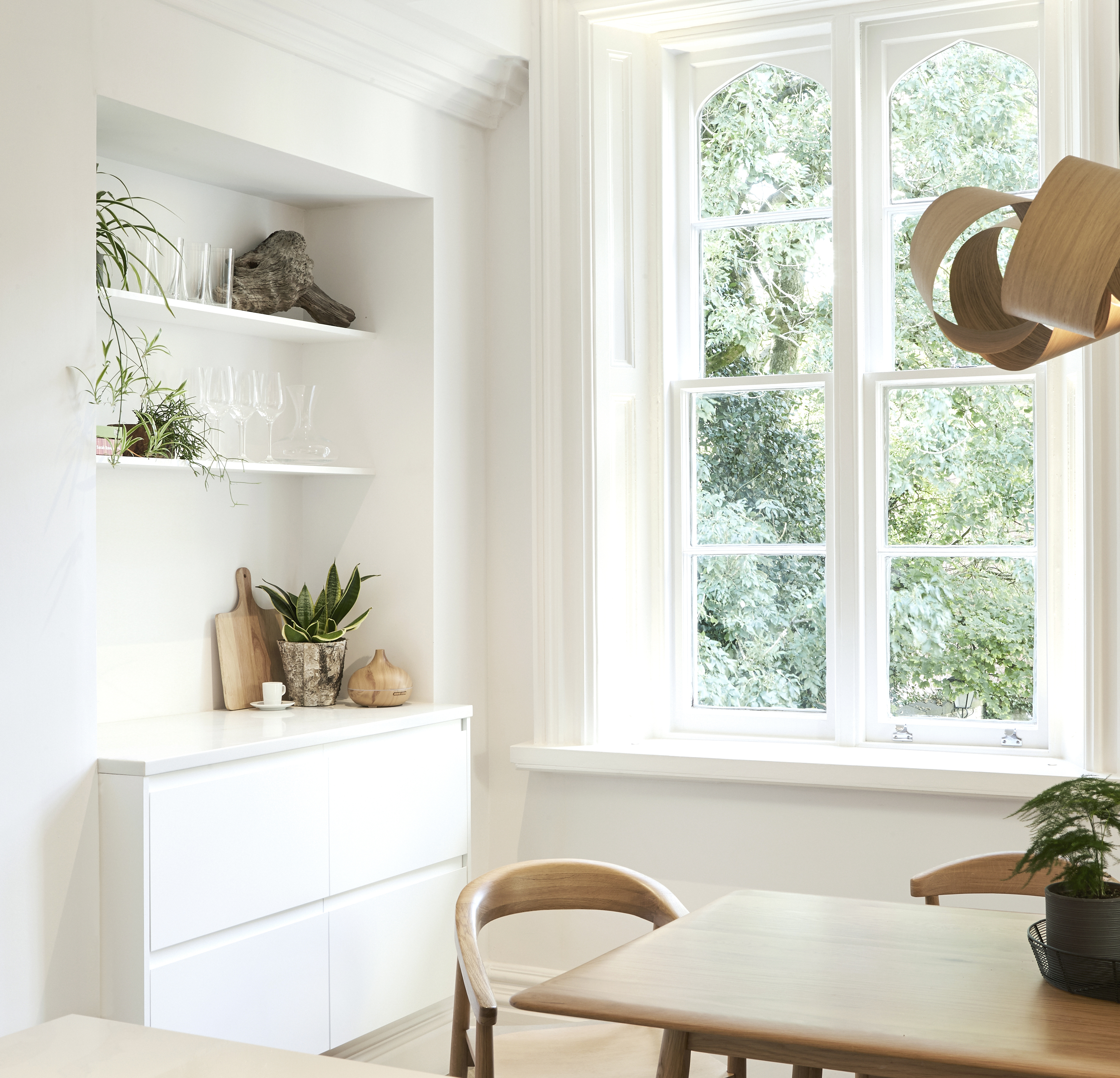 Built in breakfast bar in white kitchen with Scandinavian influence