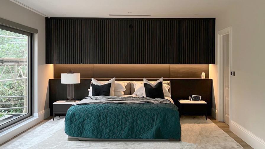 master bedroom feature wall with storage and projector in solid and veneer wood