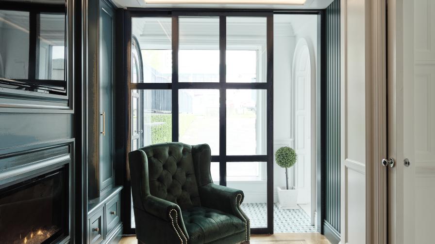 Beautiul snug area with crafted American oak herringbone floor, media unit and wooden crittall style sliding door. 