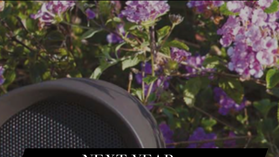 A photo of outdoor, weather resistant speakers in a flower bed. A caption reads:  "Cinema rooms aren't the only living spaces seeing a boost in. demand. Next year we're excited to explore the extended living space."