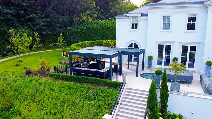 Double Louvre Pod pergola in grey with an outdoor kitchen installed