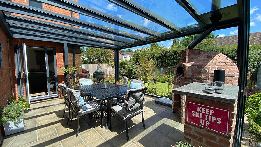 Grey framed glass room with integrated pizza oven