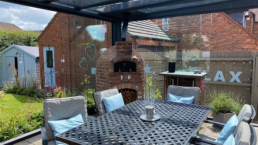 Grey framed glass room with integrated pizza oven