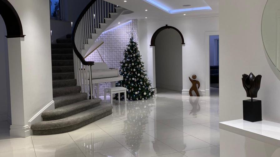 The hallway at Christmas, with tree and piano.